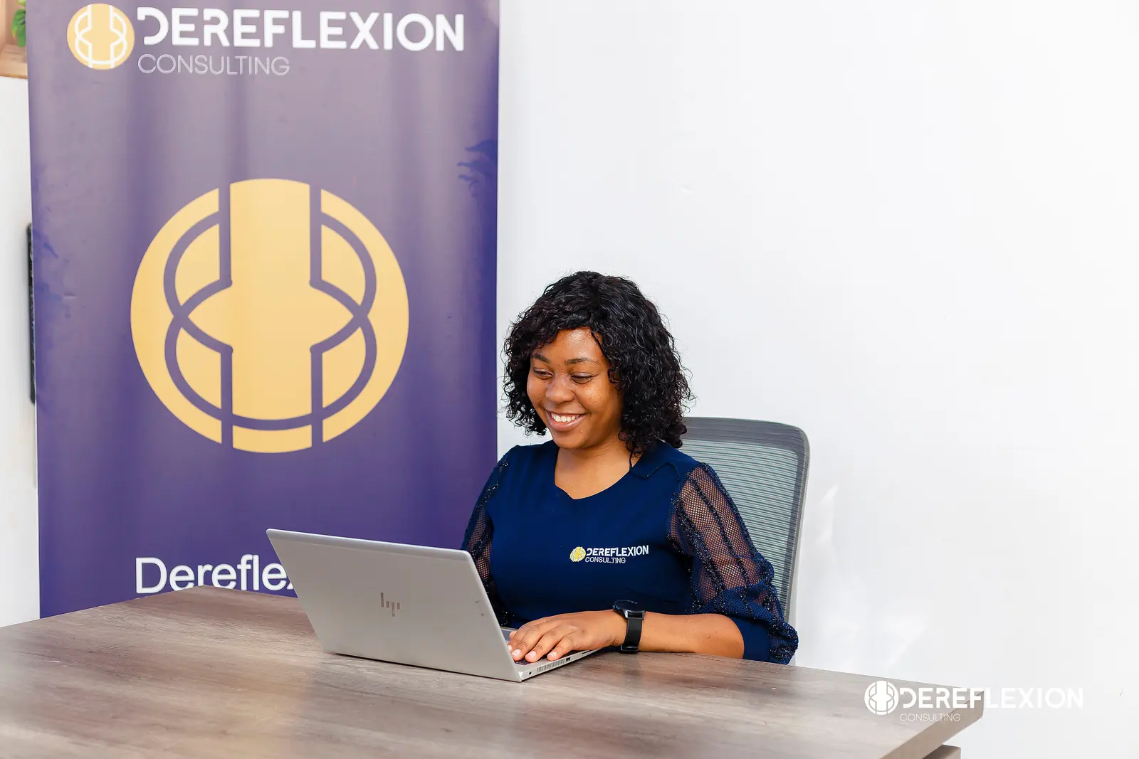 Dereflexion consultant working on a laptop in the Harare office